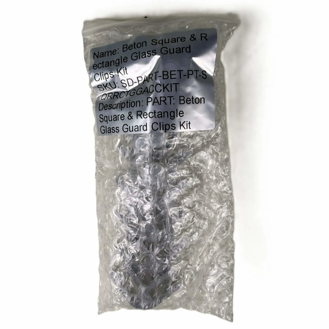 Factory-sealed Starfire Designs Béton Fire Pit Square and Rectangle Glass Wind Guard Clips Kit packaged in bubble wrap with product label and description clearly visible for secure shipping.