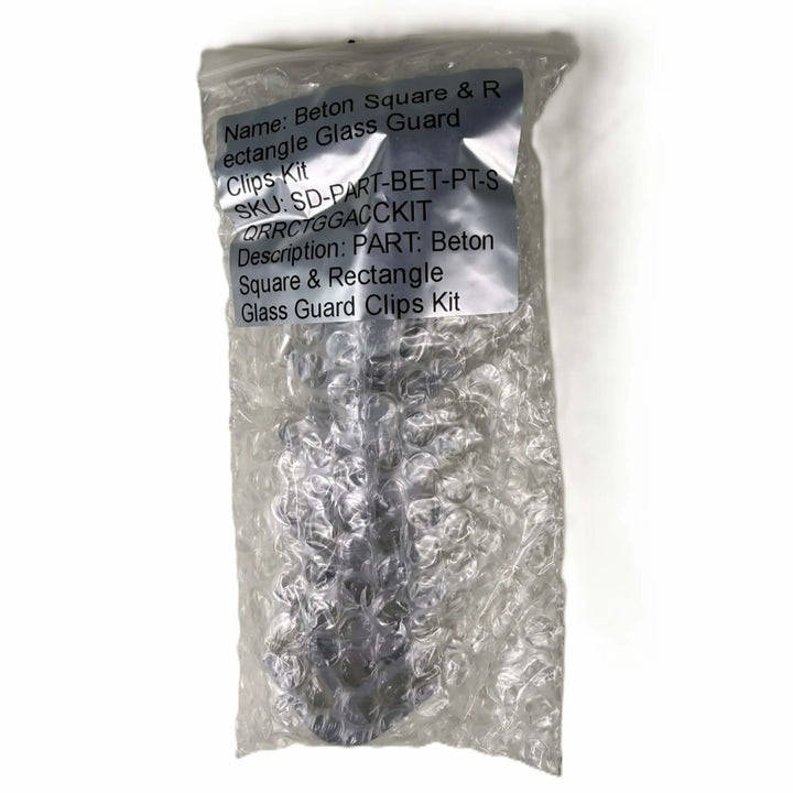 Factory-sealed Starfire Designs Béton Fire Pit Square and Rectangle Glass Wind Guard Clips Kit packaged in bubble wrap with product label and description clearly visible for secure shipping.