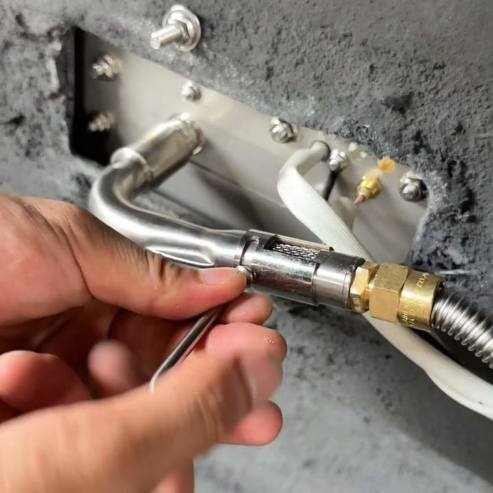 Installation of the Starfire Designs Béton Fire Pit Venturi Pipe with adjustment tool, demonstrating how to secure the stainless steel component to the gas line.