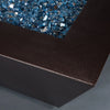 Close-up of Steel Mill 48-inch by 32-inch Rectangle Gas Fire Pit - copper vein, focusing on the textured finish and shimmering blue fire glass