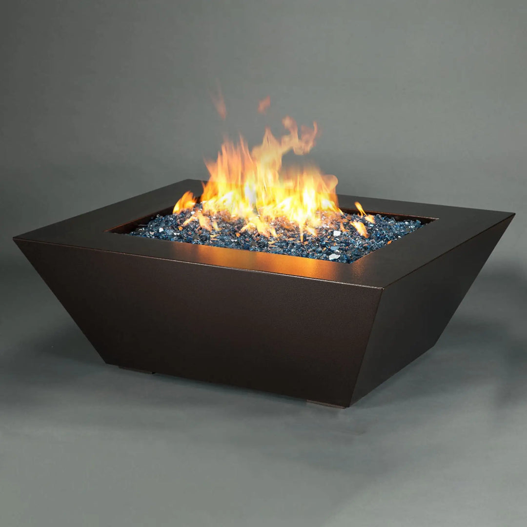 Side angle view of Steel Mill 48-inch by 32-inch Rectangle Gas Fire Pit - copper vein, showcasing the geometric design and brilliant fire display