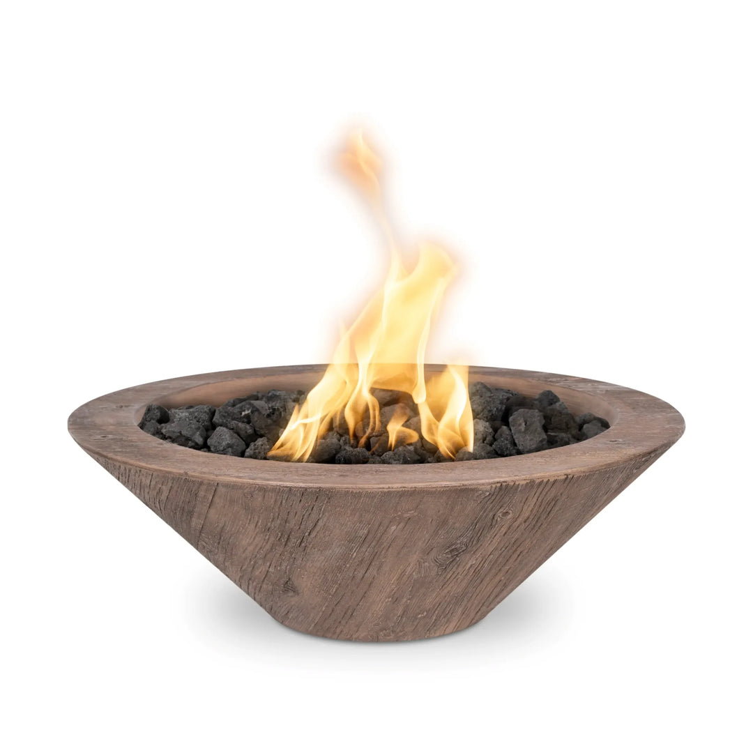 Cazo Woodgrain GFRC fire bowl in warm oak finish, featuring a rustic wood-inspired design with dancing flames over lava rock for a natural yet modern look.