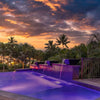 Dark Maya GFRC concrete water bowls with copper scuppers pouring smooth streams into a glowing infinity pool at sunset, adding luxury and resort-style ambiance.