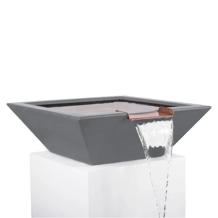 Modern square Maya Water Bowl in natural gray finish with copper spillway, pouring a smooth stream of water for a sleek poolside feature.
