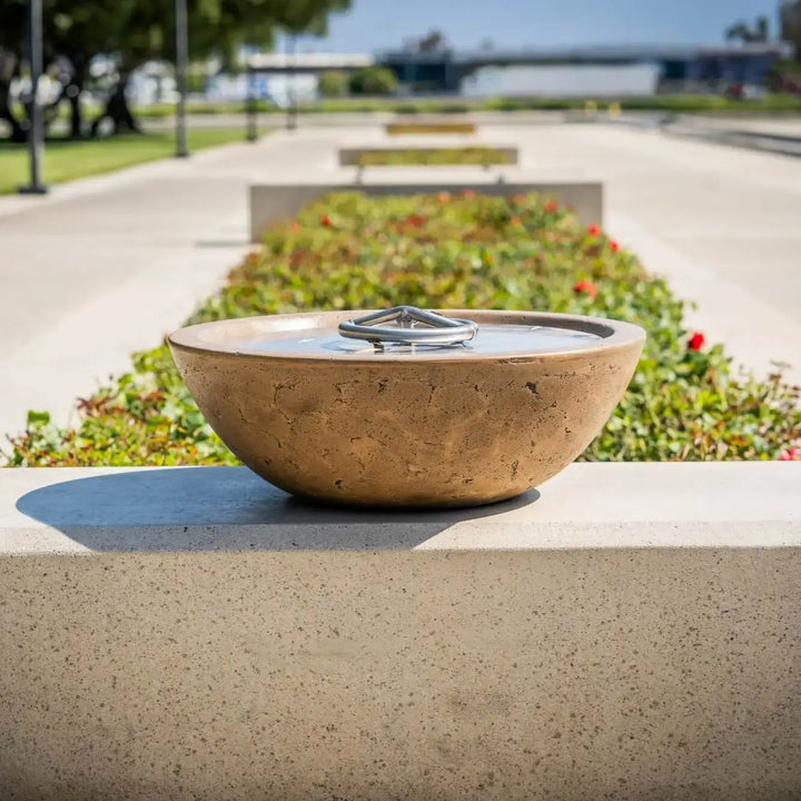 Rustic Coffee Sedona Fire Bowl installed along a stone pillar in an upscale backyard, adding cozy ambiance and decorative charm to the modern outdoor kitchen setting.