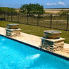 Pair of brown Sedona water bowls with copper spillways set on stone pedestals, creating elegant waterfalls into a backyard swimming pool under a clear sky.