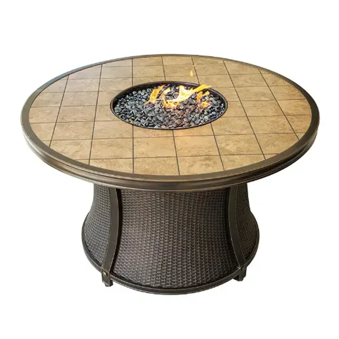 Round fire pit table with a tiled top and wicker base, featuring a central circular burner with fire glass, perfect for enhancing outdoor living spaces