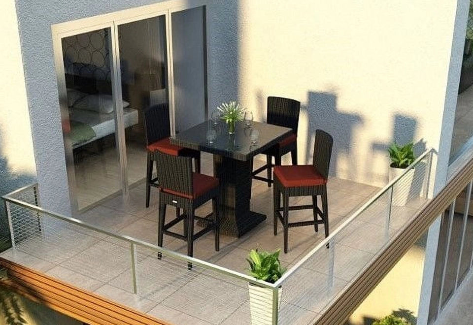 Stylish balcony bar set featuring black wicker bar chairs with red cushions and a sleek glass-top table, perfect for compact outdoor dining spaces.