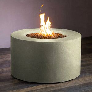 Lit flames inside the Beton 42-inch round concrete gas fire pit in sand color, creating a warm and inviting atmosphere