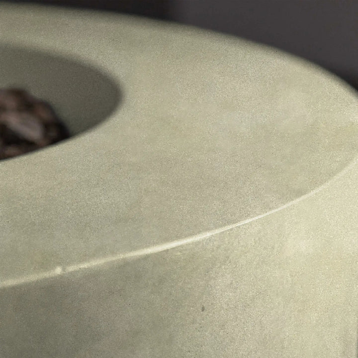 Detailed view of the surface texture of the Beton 42-inch round concrete gas fire pit in sand color