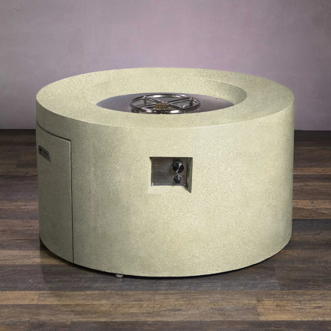 Top view of Beton 42-inch round concrete gas fire pit in sand color, featuring an access door for easy propane tank storage