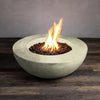 Stylish Beton 42-inch round concrete natural gas fire pit in sand color, with lava rocks and flames burning brightly, ideal for outdoor gatherings