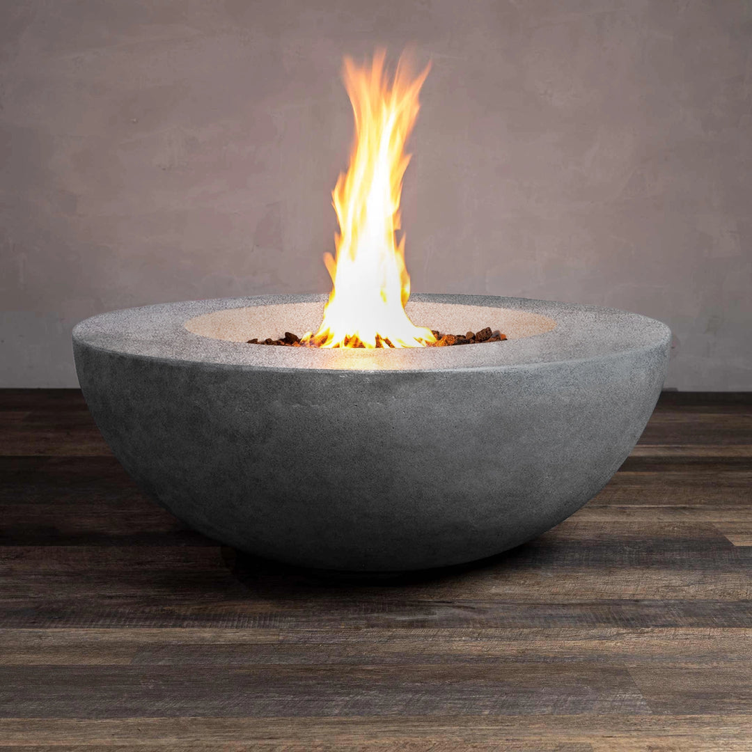 Front view of the Beton 42-inch round natural gray concrete fire pit with natural gas, showing vivid flames emerging from the lava rocks. The durable concrete construction and modern design make this fire pit a stylish centerpiece for outdoor spaces.