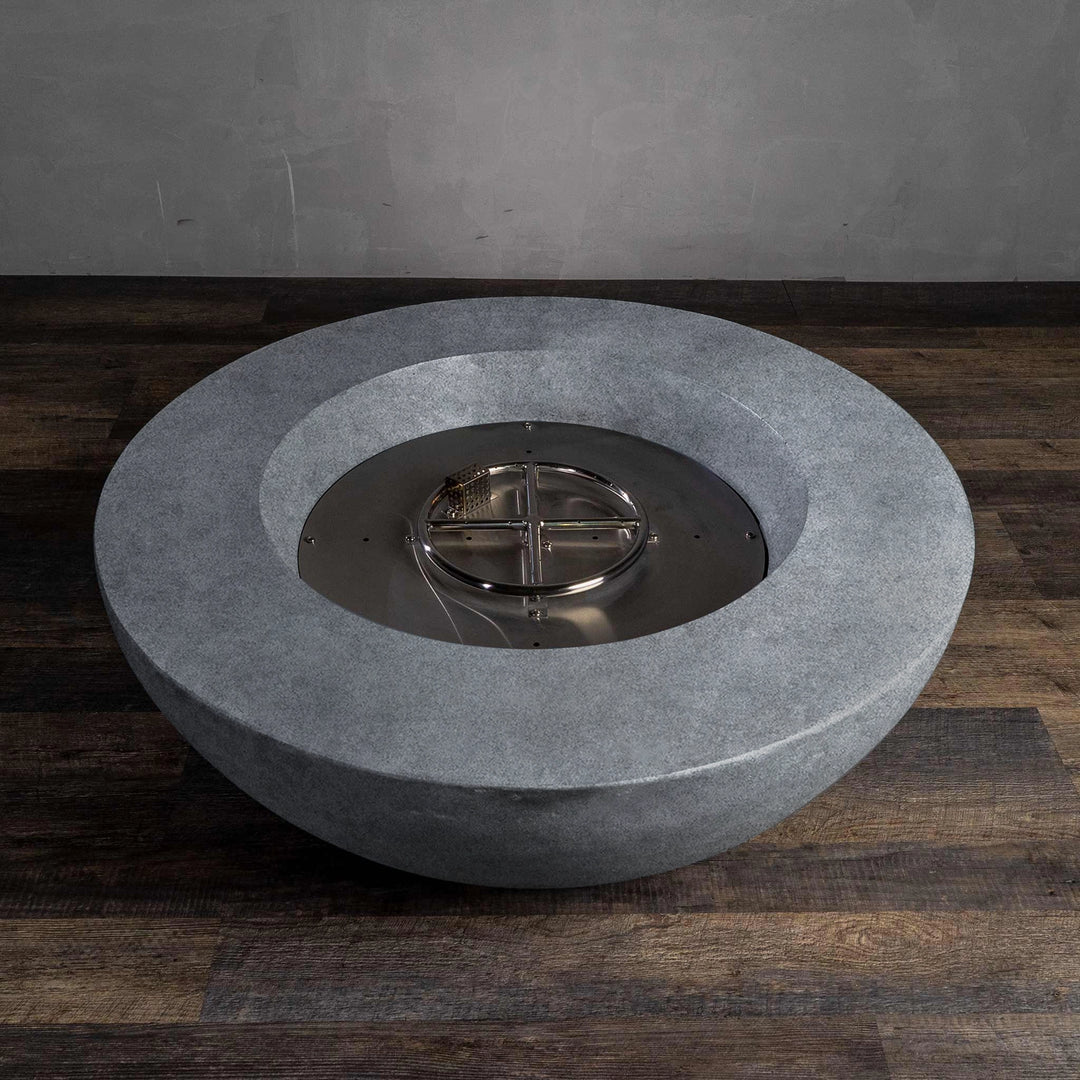  Top-down view of the Beton 42-inch natural gray round concrete fire pit showing the natural gas burner system. The stainless steel burner is housed within the durable concrete body, providing a reliable, consistent flame output for outdoor entertaining.