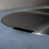 Close-up view of the Starfire Designs Beton Round Stainless Steel Burner Cover, highlighting the precision-cut edge and smooth stainless steel finish