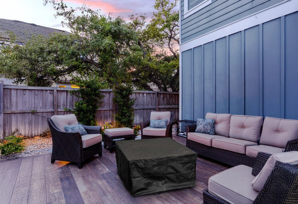 Durable black rectangular outdoor fire pit cover providing weatherproof protection for fire tables and gas fire pits. The heavy-duty cover shields against rain, UV rays, and outdoor elements, preserving fire pit longevity and maintaining a neat patio appearance.