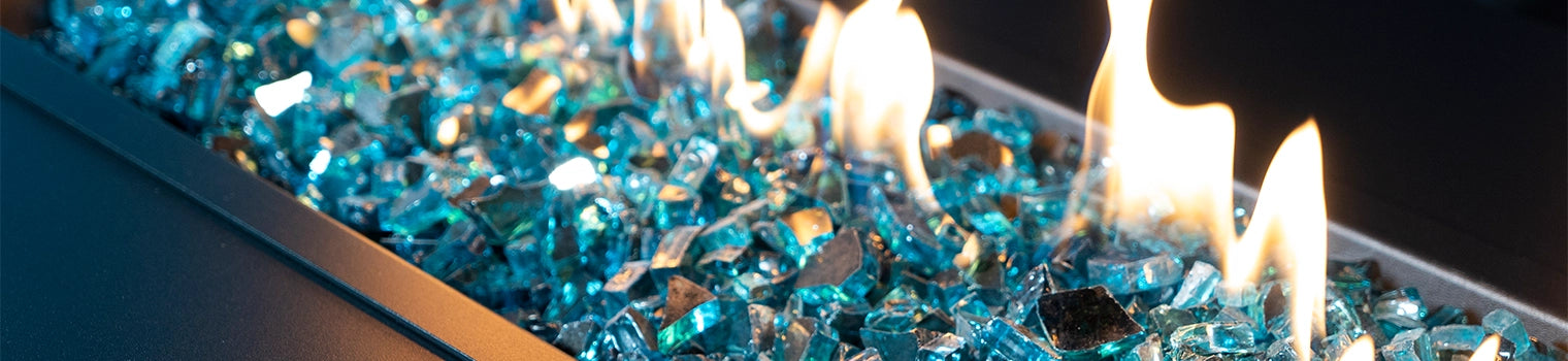 Close-up of blue fire glass crystals with flames in a rectangular luxurious fire pit