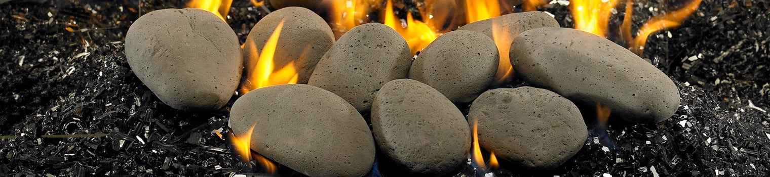 Close-up of fireplace media featuring decorative lava rocks with flames in the background