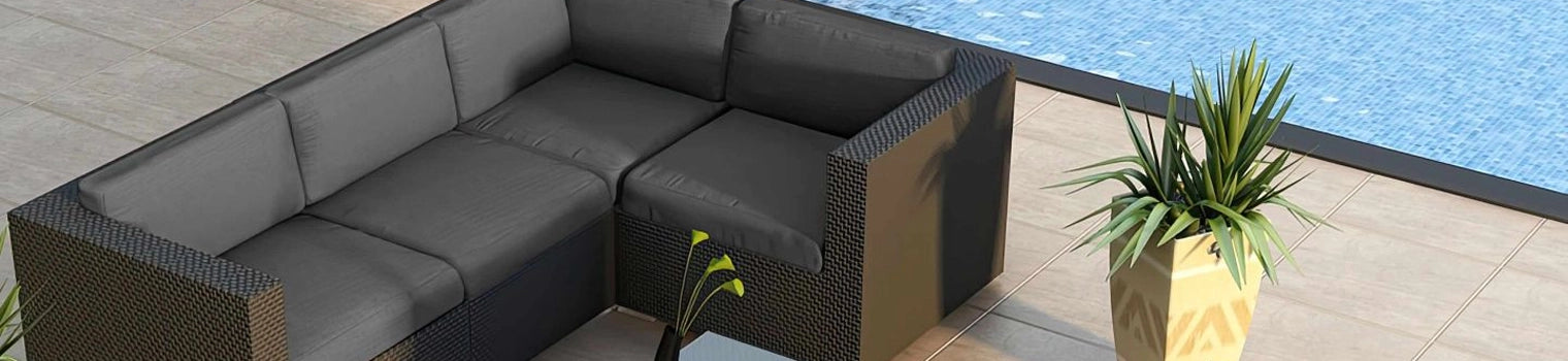 Modern outdoor patio sectional with dark cushions placed beside a pool, featuring a contemporary wicker design and a large potted plant, perfect for outdoor relaxation and entertainment.