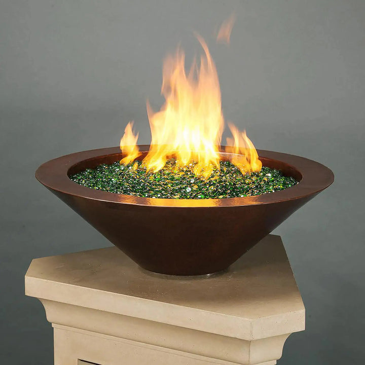 Cono Moreno 31-inch Round Copper Fire Bowl by Starfire Designs with vibrant green fire glass, perfect for creating a stunning modern fire pit feature in outdoor living spaces