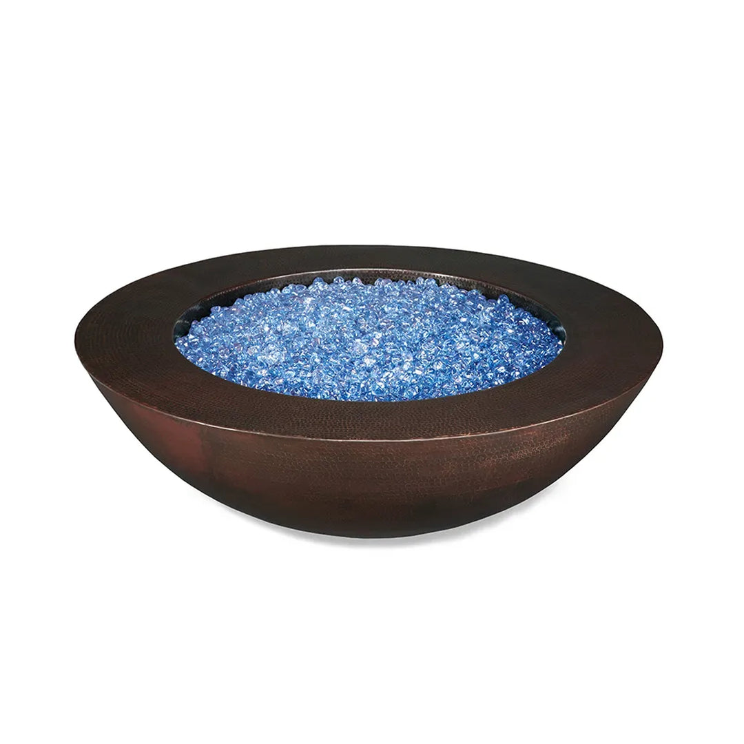 Round copper fire pit bowl filled with blue fire glass, isolated on a white background