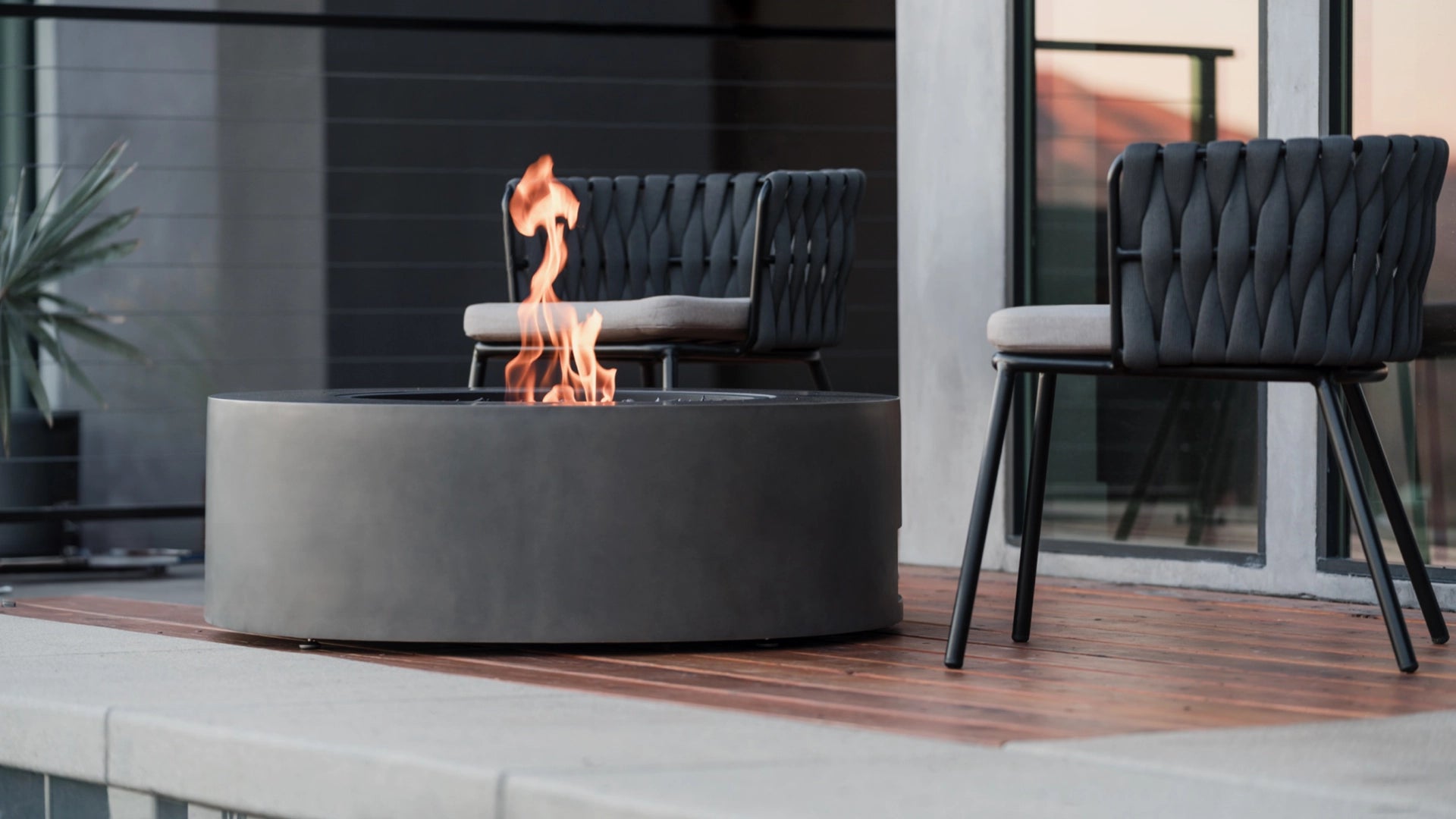 EcoSmart Fire Ark 40 bioethanol fire table on a modern outdoor deck with contemporary chairs, creating a stylish and eco-friendly outdoor setting.