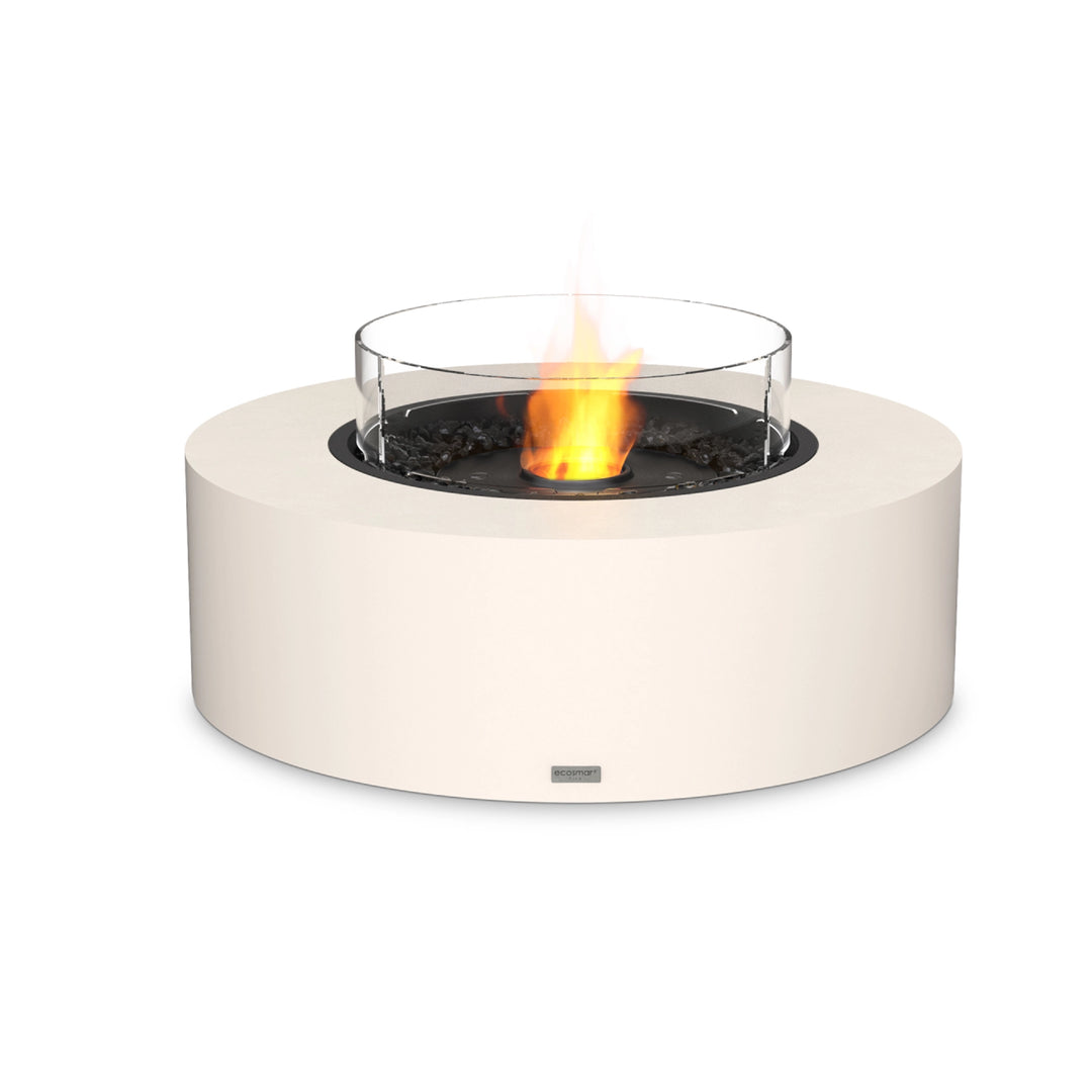 EcoSmart Fire Ark 40 in bone finish featuring a black burner with a protective glass wind guard. This round fire pit offers a modern and sophisticated aesthetic, perfect for outdoor fire pit setups. The high-quality concrete construction ensures durability, while the ethanol burner provides a smokeless and clean-burning flame. Ideal for backyard fire pits, luxury outdoor spaces, and modern fire pit designs.