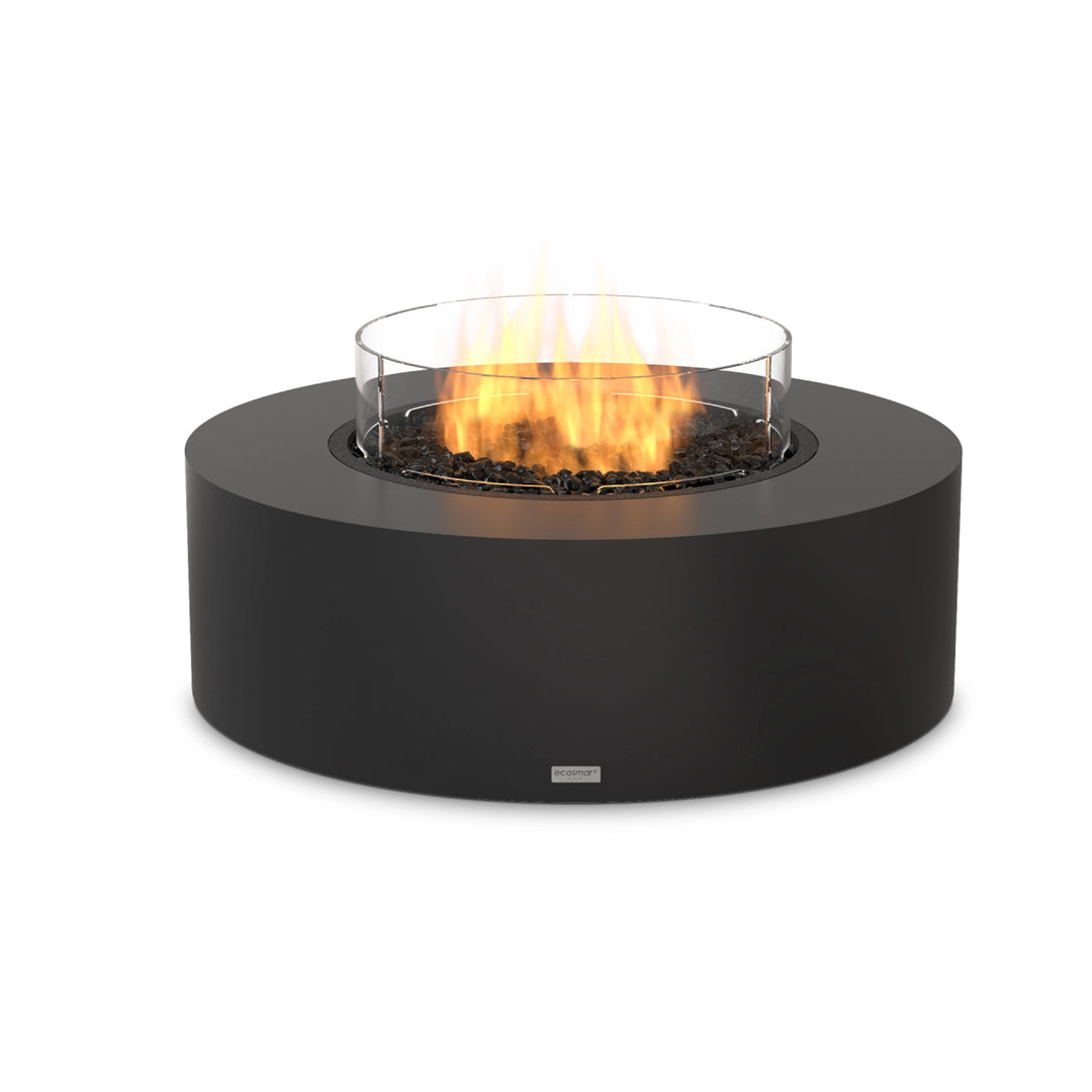 The EcoSmart Fire Ark 40 in graphite concrete finish, featuring a propane gas burner with a protective glass wind guard. This outdoor fire pit offers a warm, inviting ambiance with adjustable flames. Built for weather resistance and durability, it provides a smokeless, clean-burning fire experience perfect for modern patios, commercial outdoor areas, and backyard relaxation.