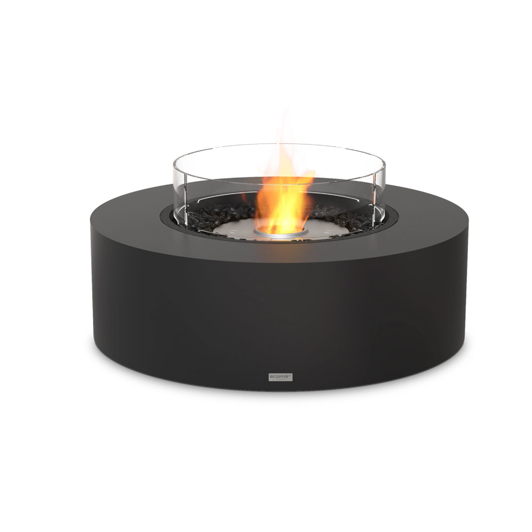 The EcoSmart Fire Ark 40 graphite fire pit, featuring a stainless steel ethanol burner with a protective glass wind guard. This luxury outdoor fire pit blends modern design with durable materials, creating a bold centerpiece for patios, rooftops, and backyard lounges. The stainless steel burner provides a clean-burning, eco-friendly fire, surrounded by sleek black fire media for a striking contrast.