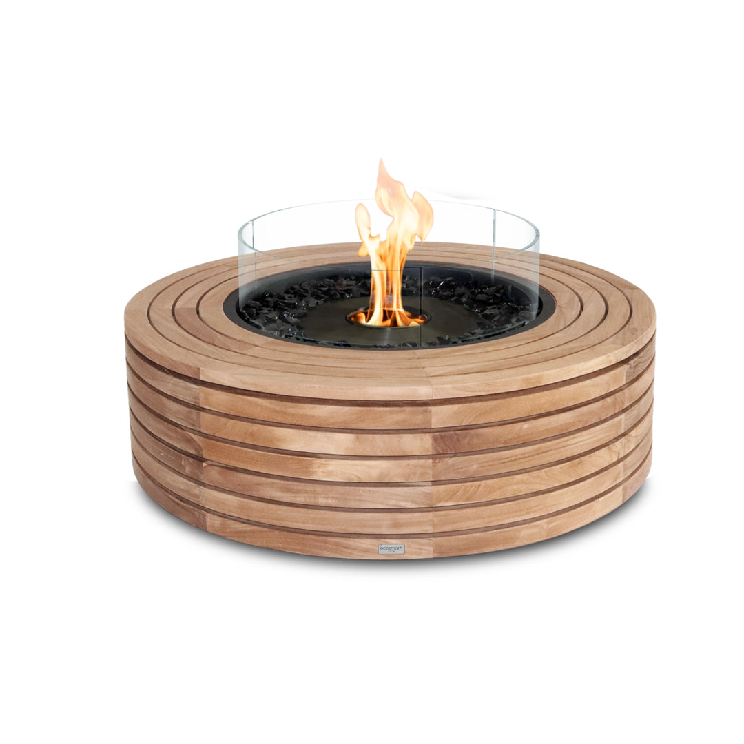 The EcoSmart Fire Ark 40 Teak fire pit features a black ethanol burner with a protective glass wind guard, designed to enhance flame stability while adding a sleek modern look. This outdoor fire pit is constructed with durable teak wood in a slatted circular design, offering a natural aesthetic with clean lines. Perfect for backyard gatherings, this freestanding fire pit brings warmth and ambiance to any outdoor space.