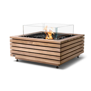 The EcoSmart Fire Base 30 Teak fire pit features a modern slatted teakwood frame with a sleek ethanol black burner at the center, enclosed by a tempered glass wind guard. This outdoor fire pit is designed for durability and elegance, offering a clean-burning, eco-friendly flame with black fire media accents. Ideal for backyard fire pits, this modern outdoor fire table enhances any patio or garden space.