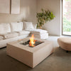 A modern indoor fire pit setup featuring the EcoSmart Fire Base 40, surrounded by plush white furniture in a minimalist living space. The fire pit’s concrete fire pit table design blends seamlessly into the decor, providing warmth and elegance as a stylish fire table propane alternative.