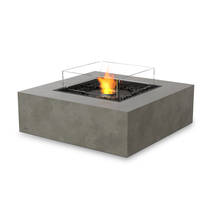 The EcoSmart Fire Base 40 Natural outdoor fire pit in a natural concrete finish features a black ethanol burner, providing a clean-burning flame with no smoke or ash. The square, modern design blends seamlessly into any backyard or outdoor patio setting. Built with durable materials, this natural gas fire pit is an ideal addition to luxury outdoor spaces.