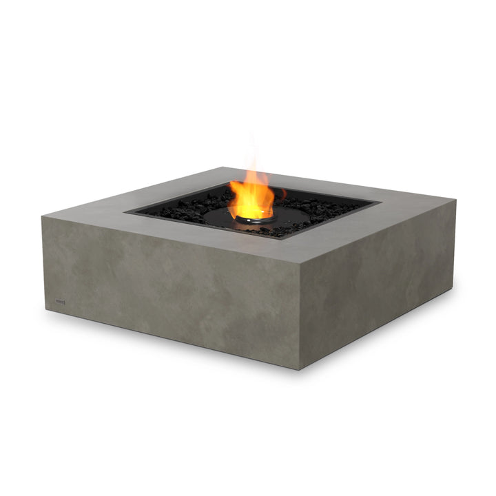 The EcoSmart Fire Base 40 Natural square natural gas fire pit features a black ethanol burner and a sleek glass wind guard, offering enhanced flame protection and safety. Designed for modern outdoor fire pit setups, this concrete fire pit table adds warmth and elegance to any luxury backyard or patio.