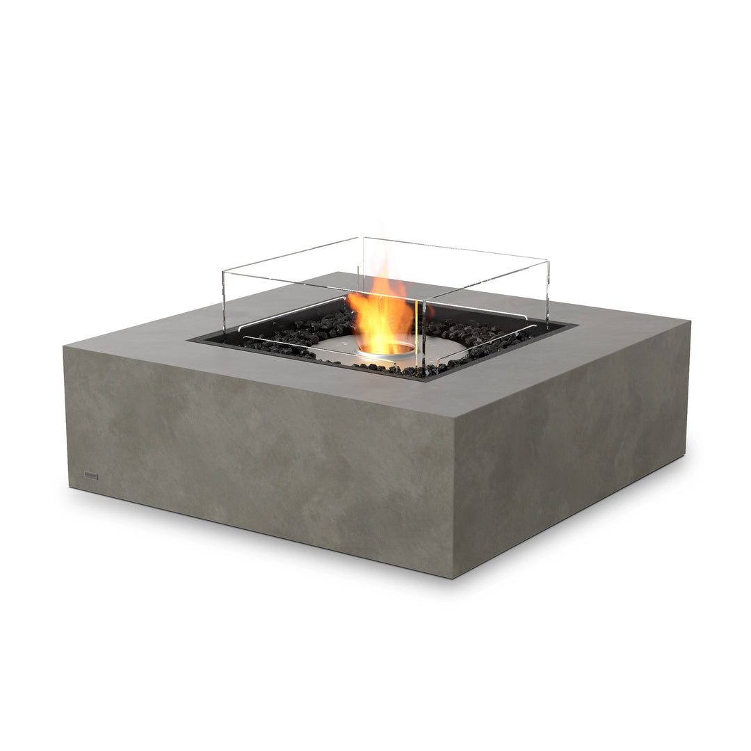 The EcoSmart Fire Base 40 Natural concrete fire pit table showcases a stainless steel ethanol burner, producing a smokeless, odor-free flame. Its modern square gas fire pit design complements luxury backyard spaces, while the natural finish blends with contemporary or rustic decor.