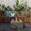 The EcoSmart Fire Chaser 38 Natural is showcased in a modern outdoor lounge, set against a backdrop of lush greenery. This outdoor fire pit is perfect for patios, backyard gatherings, and outdoor heating, adding a touch of luxury and warmth.