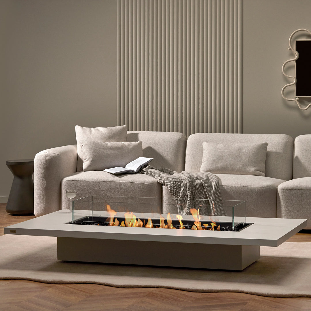 A freestanding fire pit, the EcoSmart Fire Daiquiri 70 complements a high-end living room with its sleek concrete fire table design. Ideal for luxury outdoor fire pits.