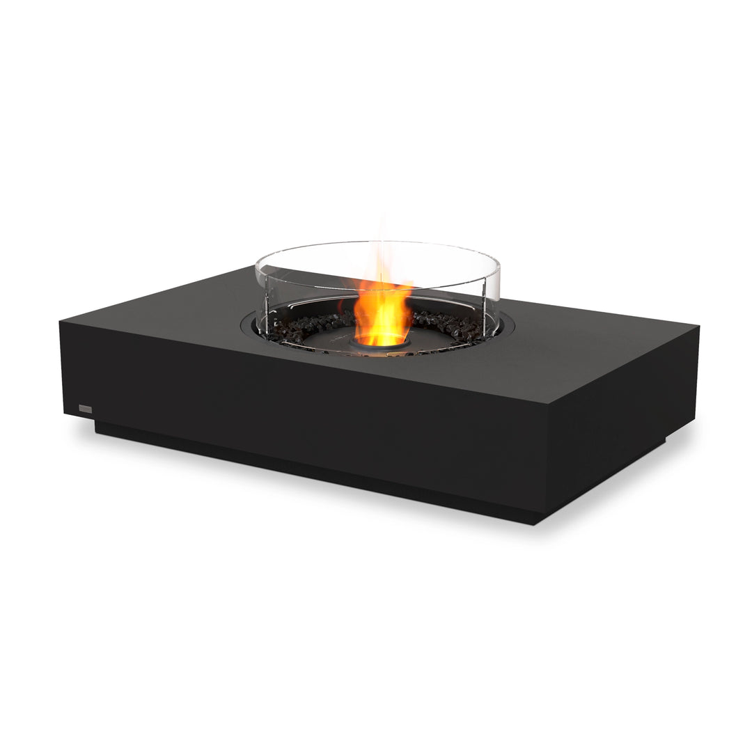 The EcoSmart Fire Martini 50 Graphite fire pit features a black burner with a glass wind guard, creating a sleek and modern focal point for outdoor or indoor spaces. Its rectangular concrete base in graphite finish complements contemporary patio designs, while the black burner with protective glass shield ensures steady flames even in breezy conditions. Ideal for luxury fire pits, outdoor fire tables, and modern patio heating solutions.