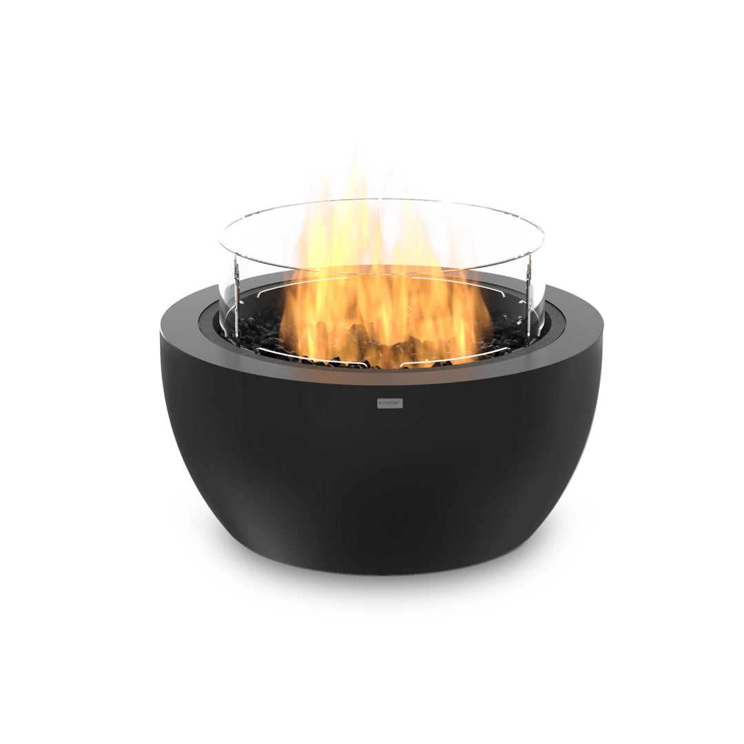 The EcoSmart Fire Pod 30 in graphite finish, designed for propane operation, comes equipped with a glass wind guard for enhanced flame stability. Its durable concrete construction and sleek round shape make it a statement piece for patios, modern backyards, and luxury outdoor spaces. This fire pit offers warmth, ambiance, and an environmentally friendly heating solution.