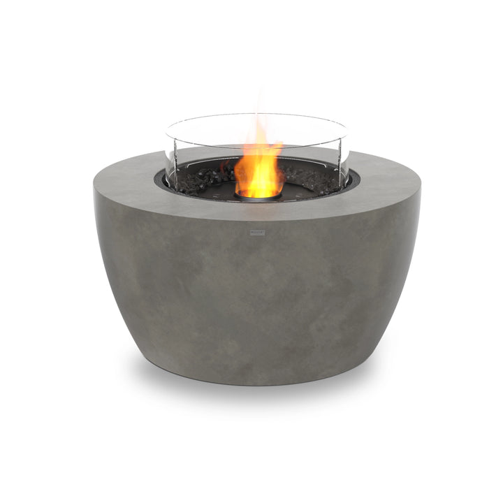 A round backyard fire pit with a natural concrete body, a black burner, and a glass wind guard for extra flame protection. The EcoSmart Fire Pod 40 is an elegant and durable outdoor fire bowl designed for contemporary patios and social spaces.