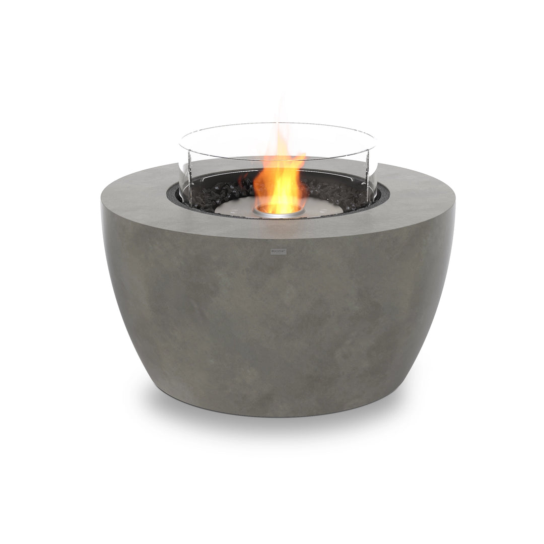 The EcoSmart Fire Pod 40 in a natural concrete finish features a stainless steel burner, black fire glass, and a glass wind guard for wind protection. This luxury fire pit provides warmth and style, making it an ideal outdoor gas fire table.