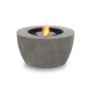 A modern outdoor fire pit with a stainless steel burner, black fire stones, and a round, natural concrete base. The EcoSmart Fire Pod 40 is designed for seamless integration into fire pits for outside or patio lounge areas.

