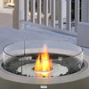 An EcoSmart Fire R530 Fire Screen placed on a round outdoor fire pit on a sleek modern balcony. The clear tempered glass shield protects the fire while maintaining an elegant aesthetic, making it a perfect addition to any outdoor fire pit setup for balconies, patios, or deck spaces.