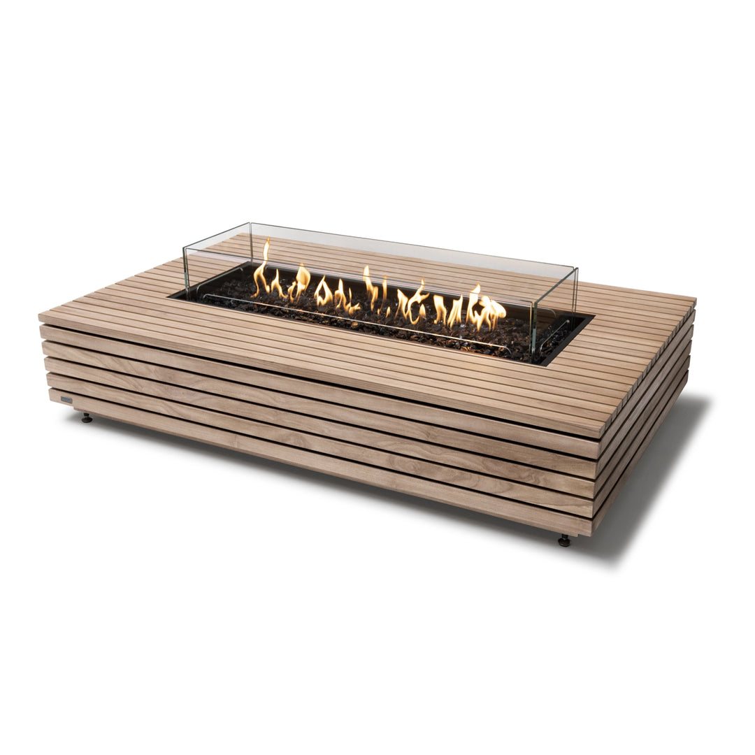 EcoSmart Fire Wharf 50 Teak propane gas fire pit with a glass wind guard, featuring a durable slatted teak wood exterior and a contemporary rectangular fire table design. This high-end fire pit is designed for luxury outdoor living, adding warmth and ambiance to backyard patios, poolside lounges, and modern outdoor spaces. The adjustable propane gas burner delivers a beautiful, flickering flame over fire glass.