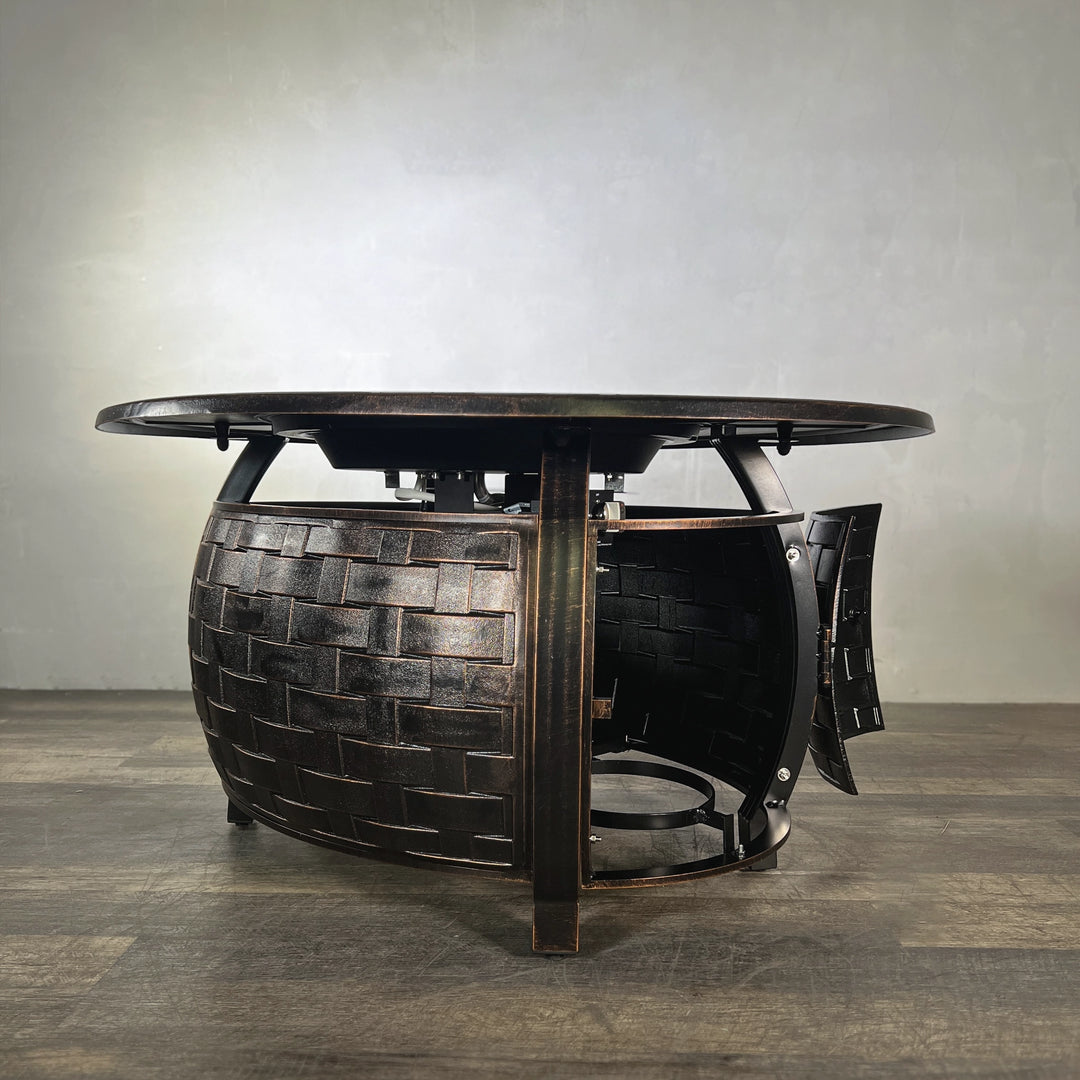 Side view of the Golden Flame Bel Air 48” Oval Cast Aluminum Natural Gas Fire Table with an open access door to showcase its propane tank storage and craftsmanship