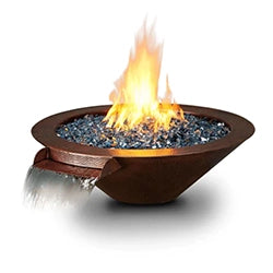 Round fire pit with a rustic brown finish, blue fire glass, flames, and a built-in water feature cascading from one side