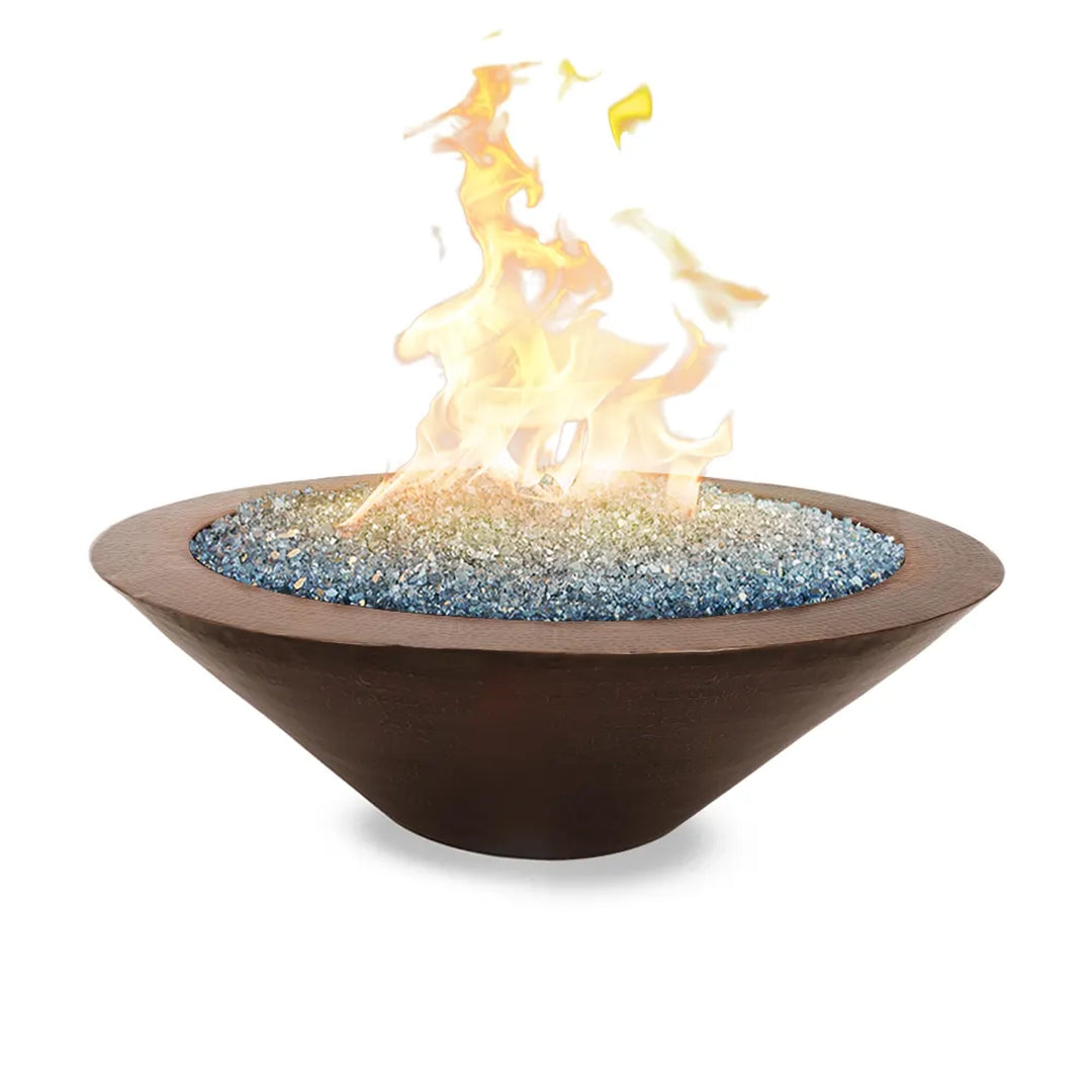 Copper fire pit bowl filled with blue and clear fire glass, featuring vibrant flames, ideal for creating a warm and inviting atmosphere in outdoor spaces