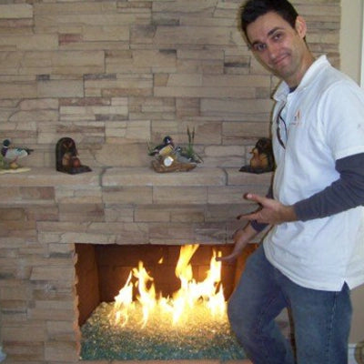 Jonathan Burlingham, founder of Starfire Direct, setting up fire glass in a fireplace during the early years of the business.