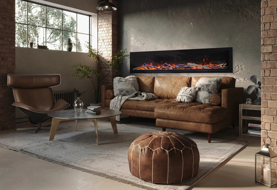 Chic long wall-mounted electric fireplace with realistic log set and vibrant flames, enhancing a modern industrial living room with exposed brick walls and a cozy leather sofa. The sleek design offers warmth and ambiance, perfect for contemporary home interiors.