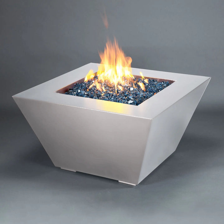 Angled view of the Mill 40-inch Square Steel Gas Fire Pit - White Hammertone with a bright flame. This modern fire pit is perfect for creating a warm, inviting outdoor space